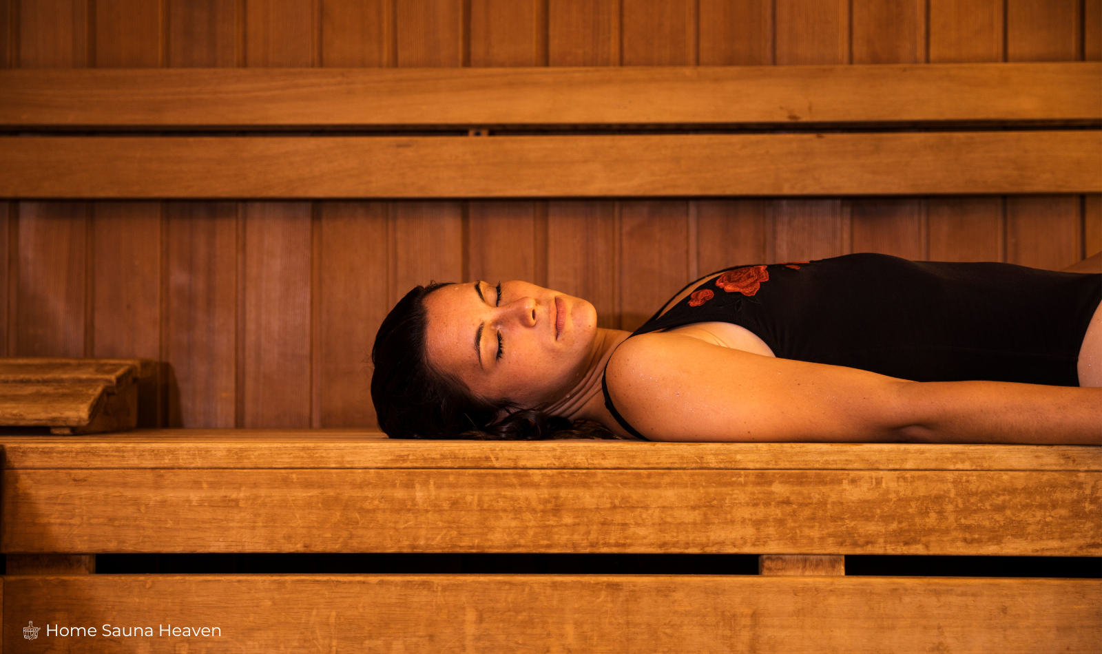 woman sleeping on a sauna bench